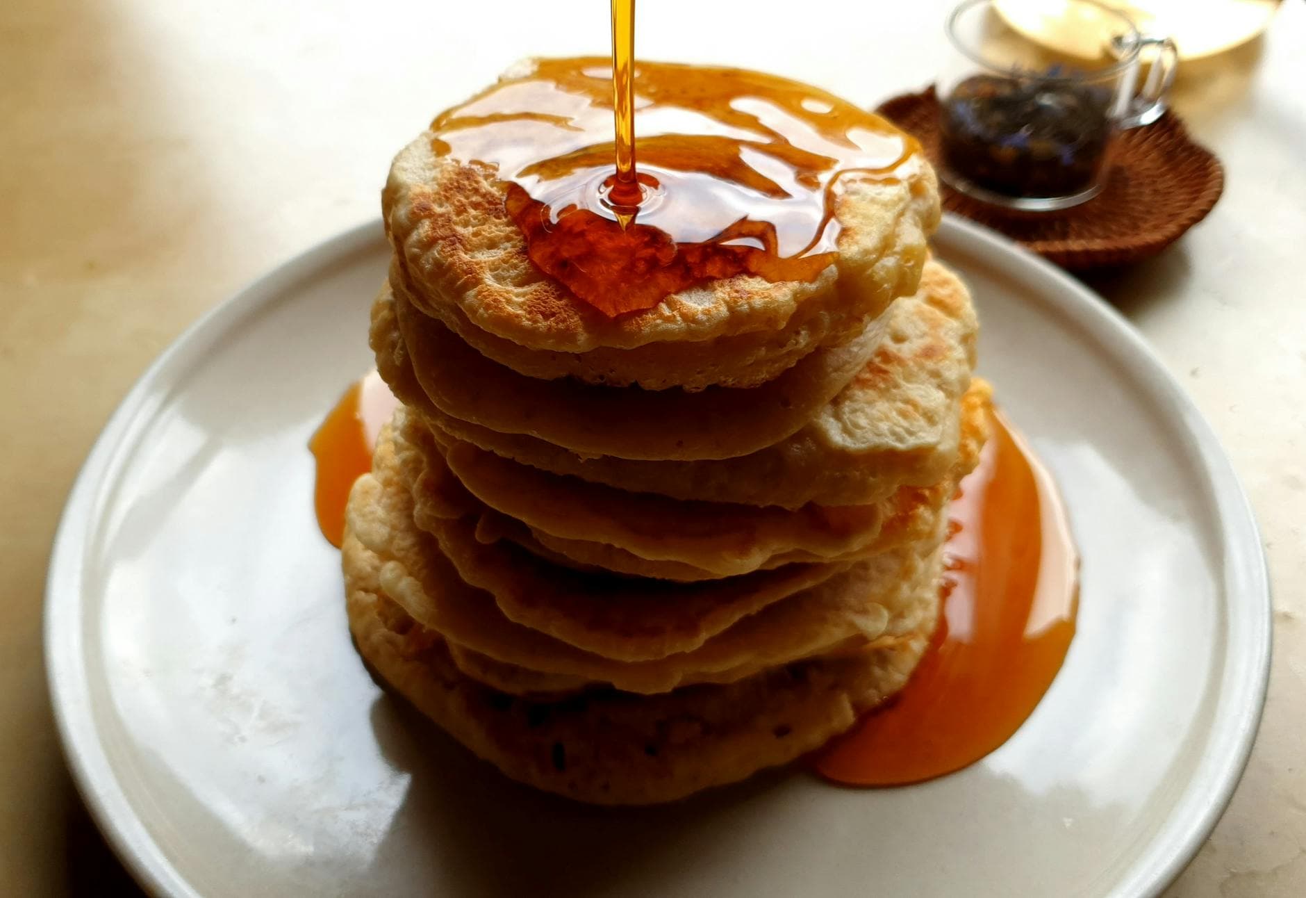 Stack of fluffy breakfast pancakes with syrup