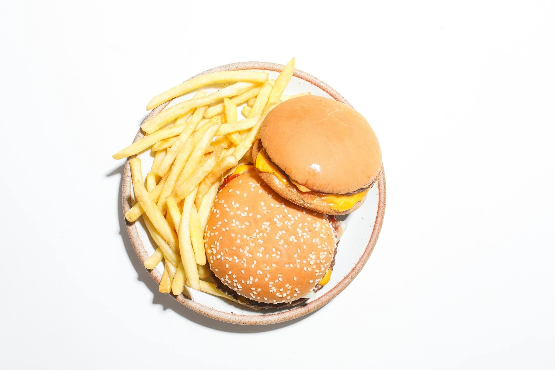 Juicy cheeseburger and fries on a plate